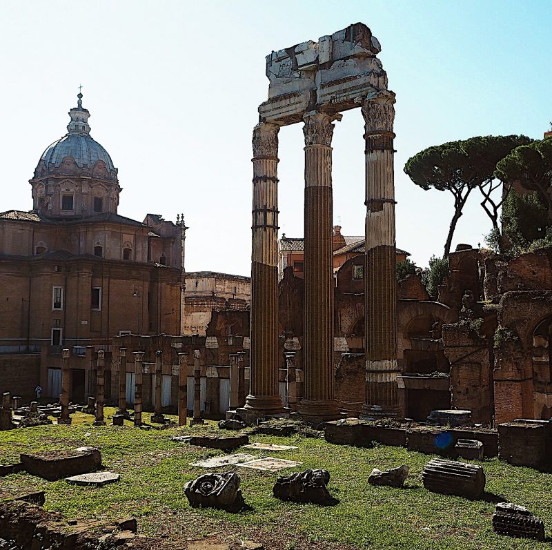 Veduta panoramica dei Fori Imperiali con colonne antiche sotto cielo azzurro